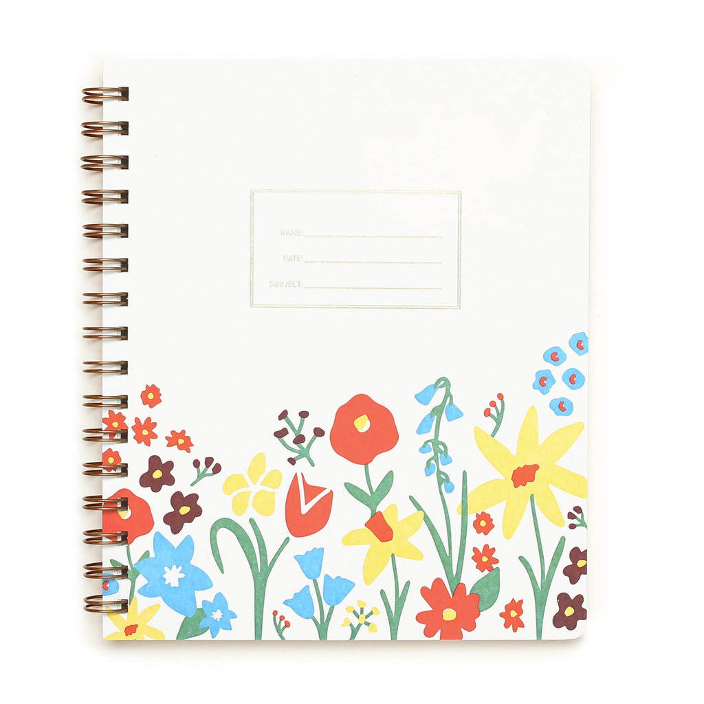 White background with garden flowers at the bottom of cover in red, yellow, blue, and green with embossed rectangle with embossed text says, “Name”, “Date” and “Subject”. Brass coil binding on left side. 