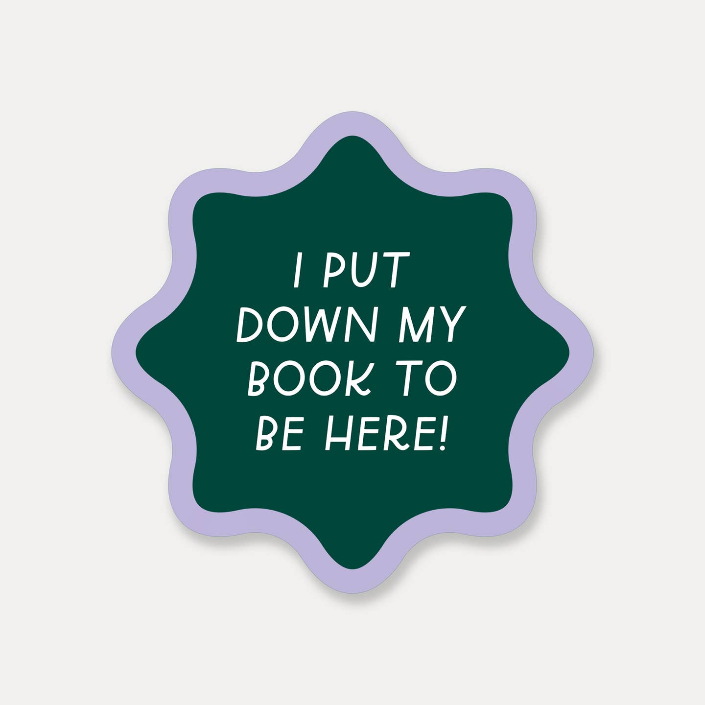 Decorative sticker with green background and lilac border with white text says, "I put down my book to be here!".