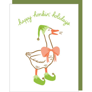 Greeting card with white background and image of a goose dressed as an elf with green hat and booties with an orange bow and beak. Green text says, "Happy honkin' holidays". Green envelope included. 