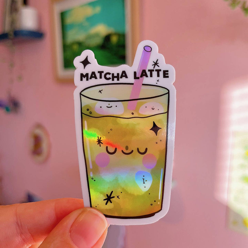 Decorative sticker in the image of glass of matcha with holographic detail and pink straw with black text says,"matcha latte". 