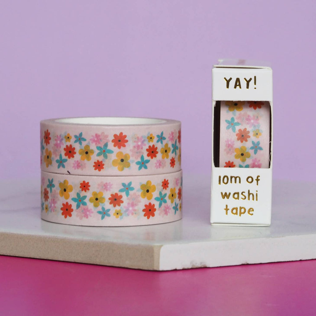 Image of Washi tape with pink background and images of flowers in orange, aqua, yellow, and pink.