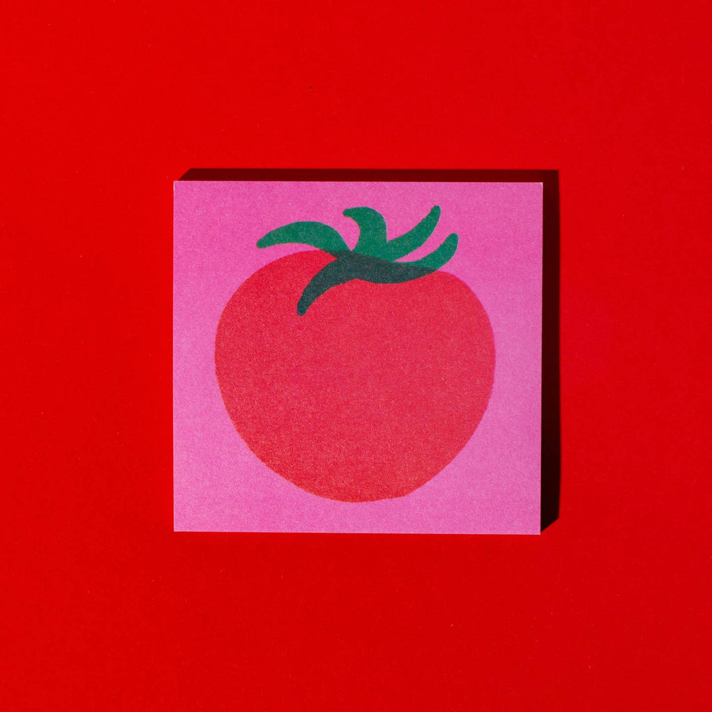 Sticky notepad with hot pink background and image of a red tomato with green stem in center.