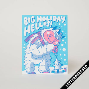 Light blue background with image of white yeti with a little tree and white text says, "Big holiday hellos!". Kraft envelope is included.