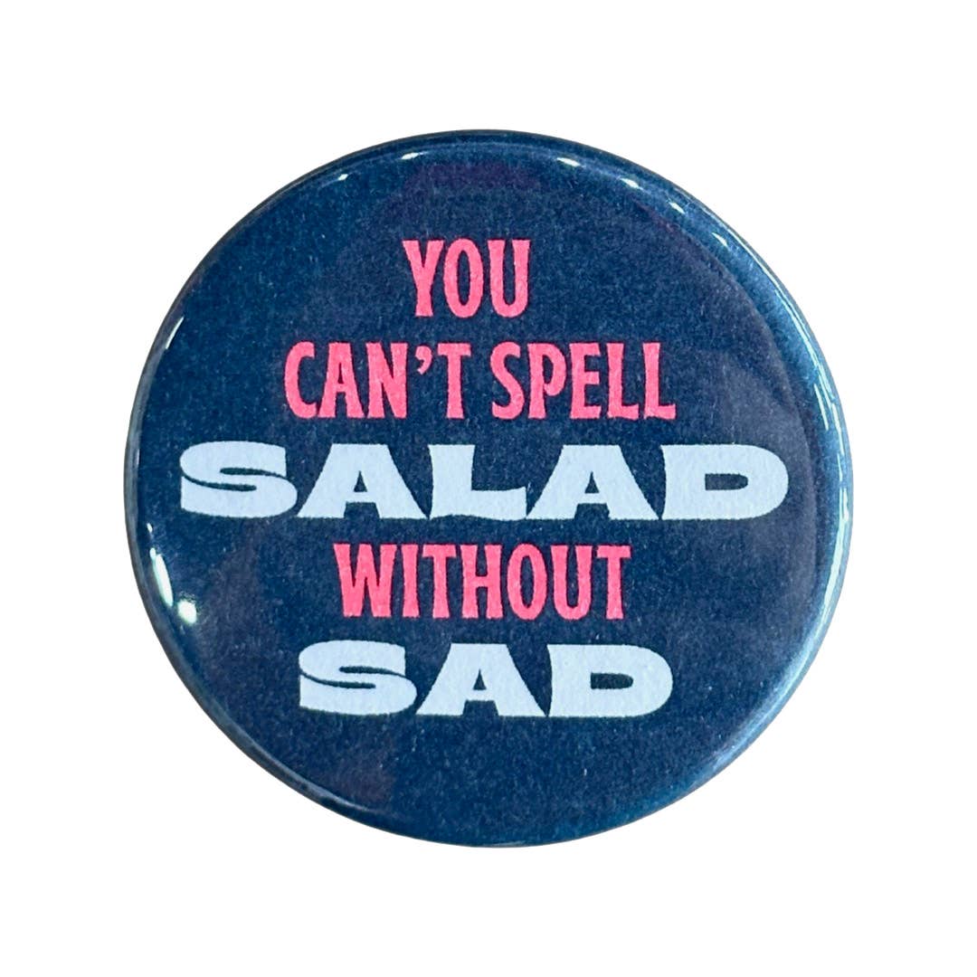 Image of button with dark blue background with orange text says, "You can't spell", white text says, "Salad", orange text says, "Without" and white text says, "sad".