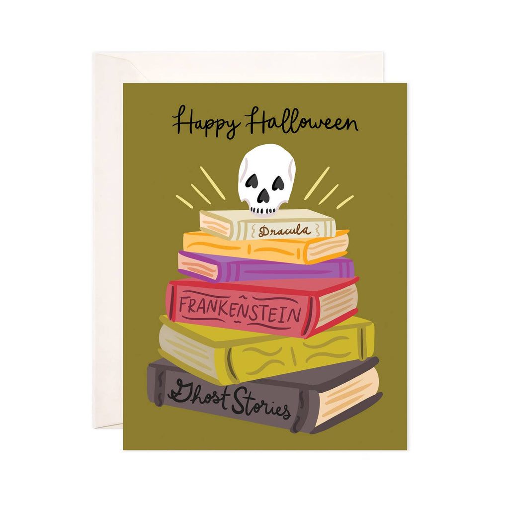Greeting card with olive green background with stack of books with skull on top. Black text says, "Happy Halloween". Books have black text says, "Dracula, Frankenstein, Ghost stories". Envelope included. 