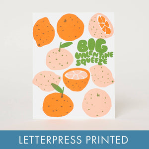 Greeting card with white background and images of oranges with green text says, "Big Valentine Squeeze". Kraft envelope included. 