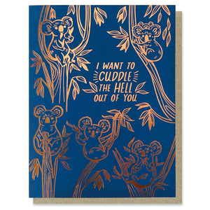 Greeting card with dark blue background and rose gold foil images of koalas in trees with foil text says, "I want to cuddle the hell out of you". Kraft envelope included. 