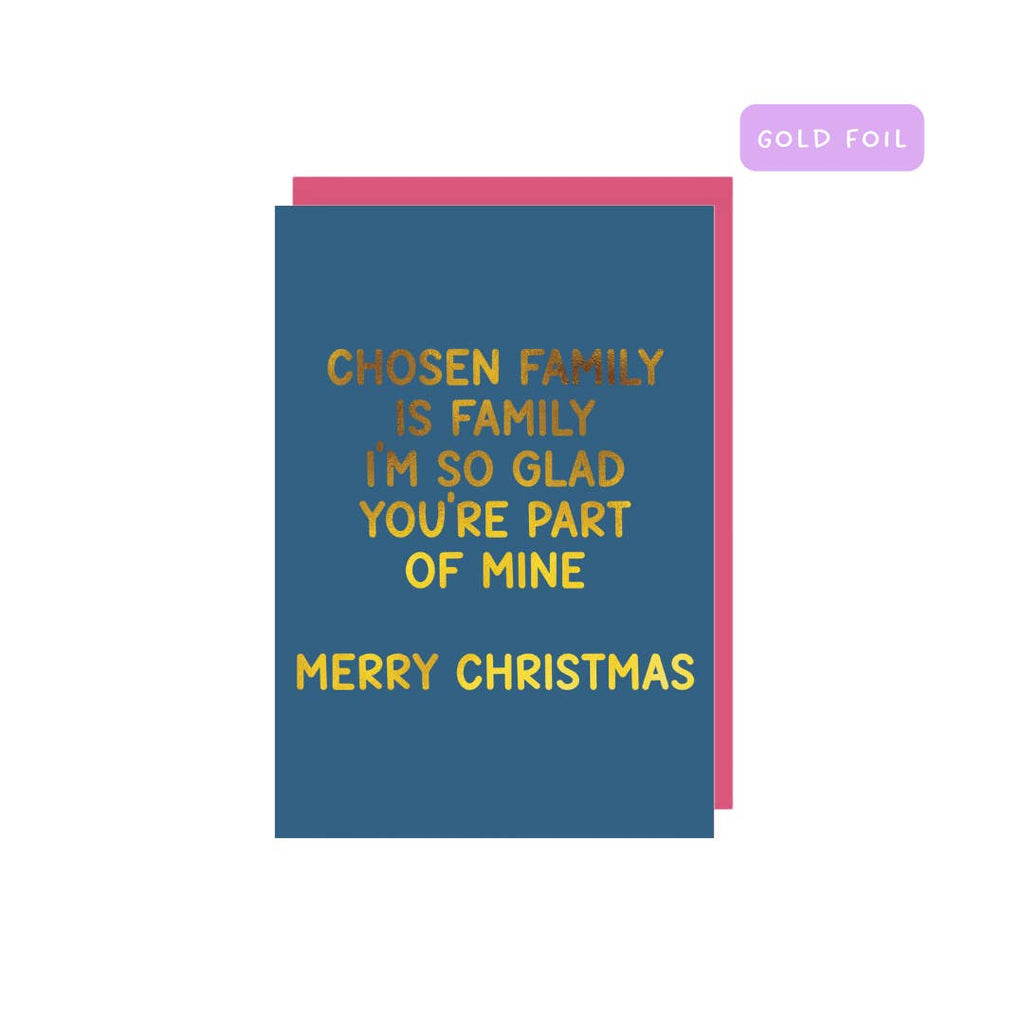 Greeting card with blue background and gold foil text says, "Chosen family is family I'm so glad you're part of mine, Merry Christmas". Pink envelope included. 