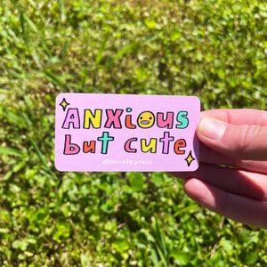 Sticker with pink background with text in yellow, red, aqua and blue says, "Anxious but cute". 