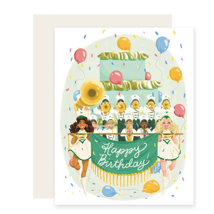 White background with image of a marching band holding a birthday cake and a banner with white text says, "Happy Birthday!". Cream envelope included. 