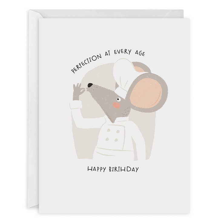 Greeting card with white background and image of a grey mouse wearing a chef's hat and coat with his fingers pinched together at this mouth. Black text says, "Perfection at every age, Happy Birthday". White envelope included.