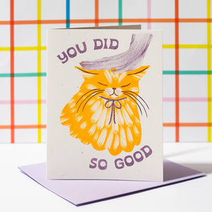 Greeting card with white background and image of yellow car with a purple hand on its head. Purple text says, "You did so good". Lilac envelope included.