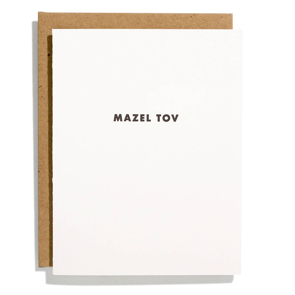 Greeting card with white background and black text says, "Mazel Tov". Kraft envelope included.