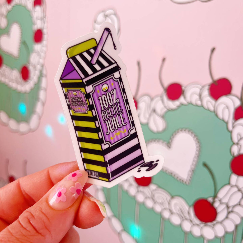 Decorative sticker with image of carton of juice in black and white stripes with purple and green accents and white text says, "100% beetlejuice". 