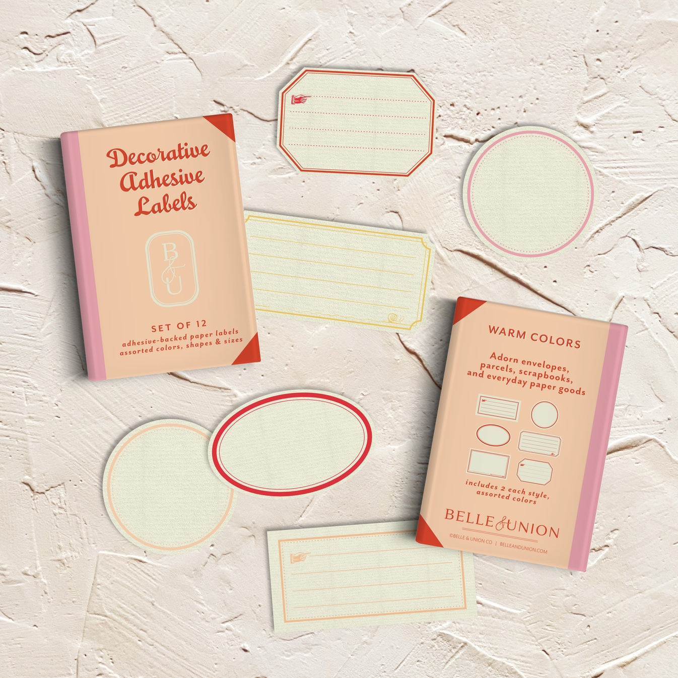 Decorative labels and box with cream background and borders in pink, red, peach and yellow.