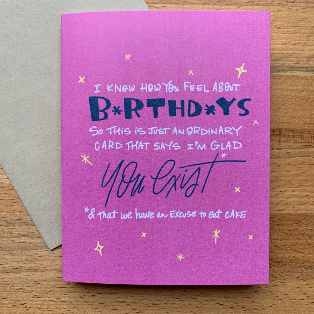 Greeting card with pink background and white and blue text says, "I know how you feel about birthdays so this is just an ordinary card that says I'm glad you exist and that we have an excuse to eat cake" and yellow sparkles,. Kraft envelope included.