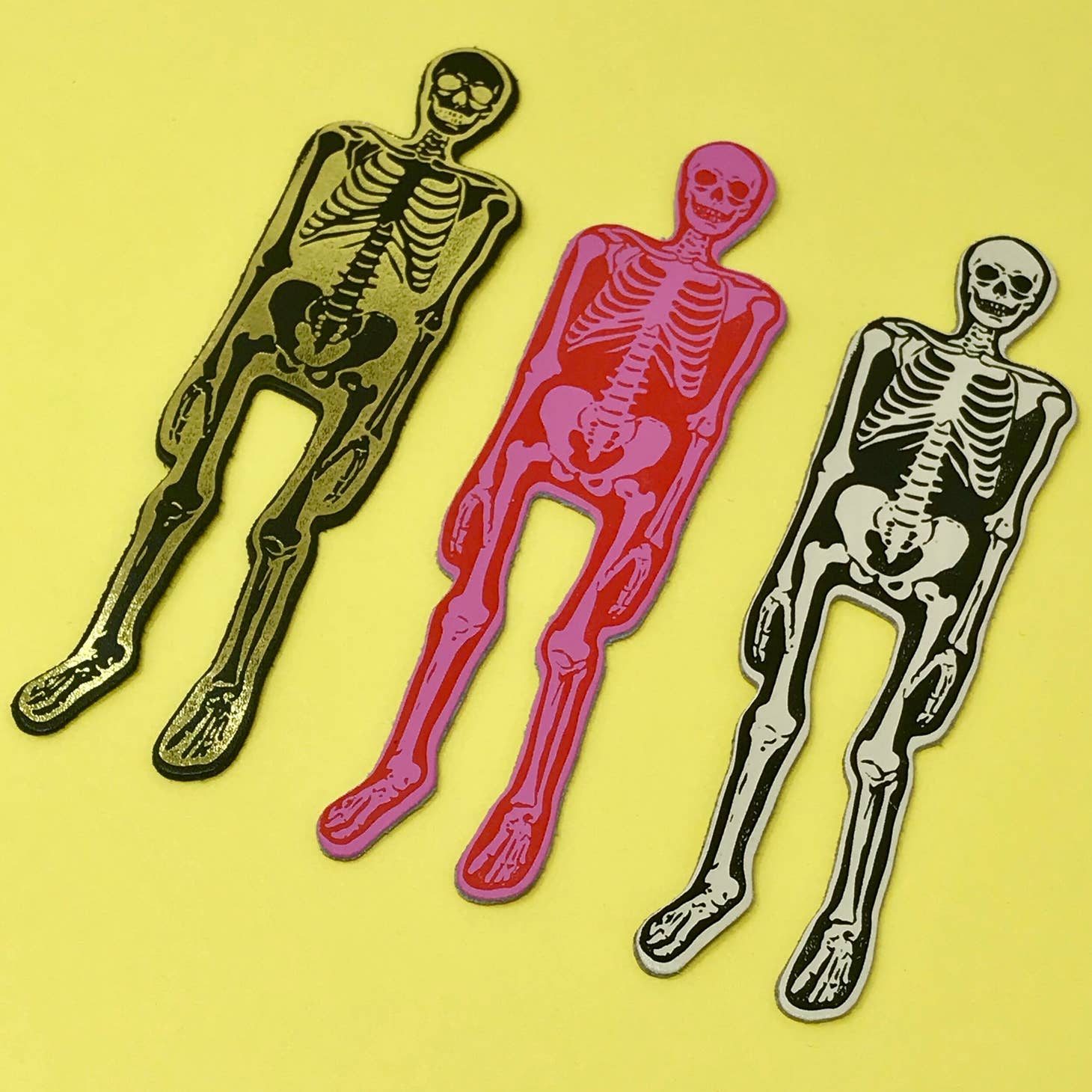 Images of three skeleton bookmarks in cream, hot pink and white. 