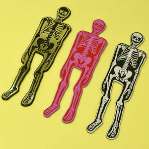 Images of three skeleton bookmarks in cream, hot pink and white. 