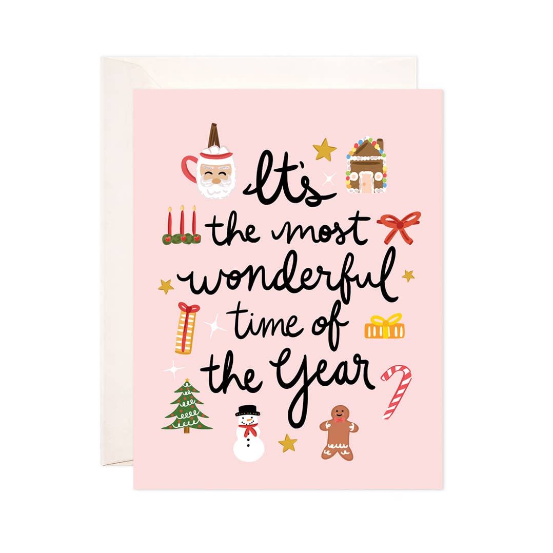 Pink background with images of gingerbread house, Santa, presents, snowman, and candles with black text says, “It’s the most wonderful time of the year”. White envelope is included.         