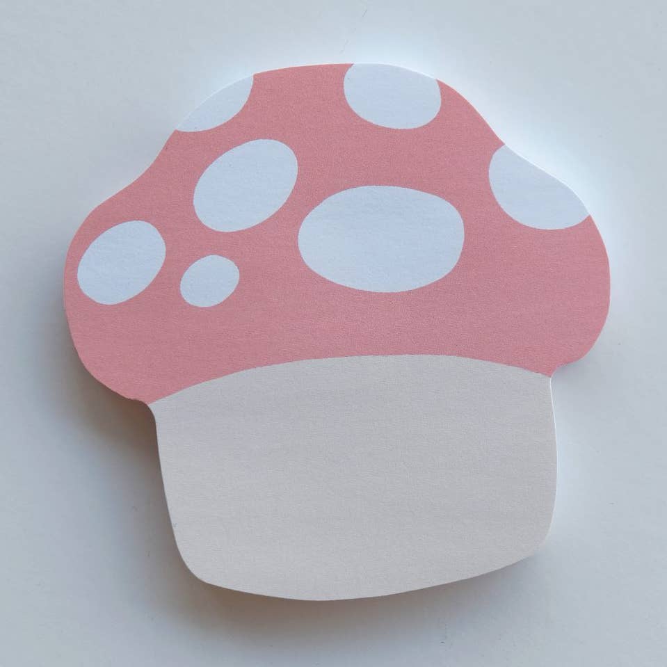 Image of sticky notepad in shape of mushroom with pink and white dotted cap and white stem.