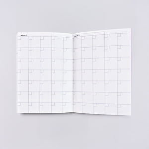 Planner page with white background and monthly calendar format. Black text says, "Month". 