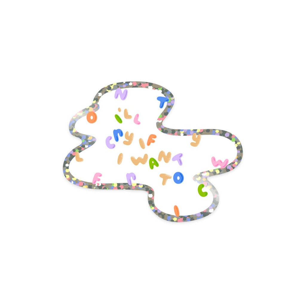 Image of sticker with glitter outline of spilled milk with multicolored text says, "I'll cry if I want to". 