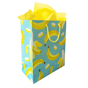 Aqua background with images of yellow bananas and ivory sliced bananas with yellow rope handle.