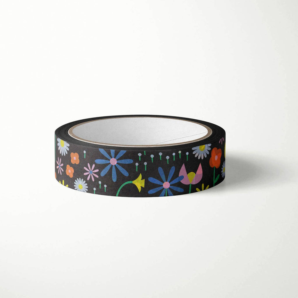 Washi tape with black background and images of flowers in blue, pink, red and yellow. 