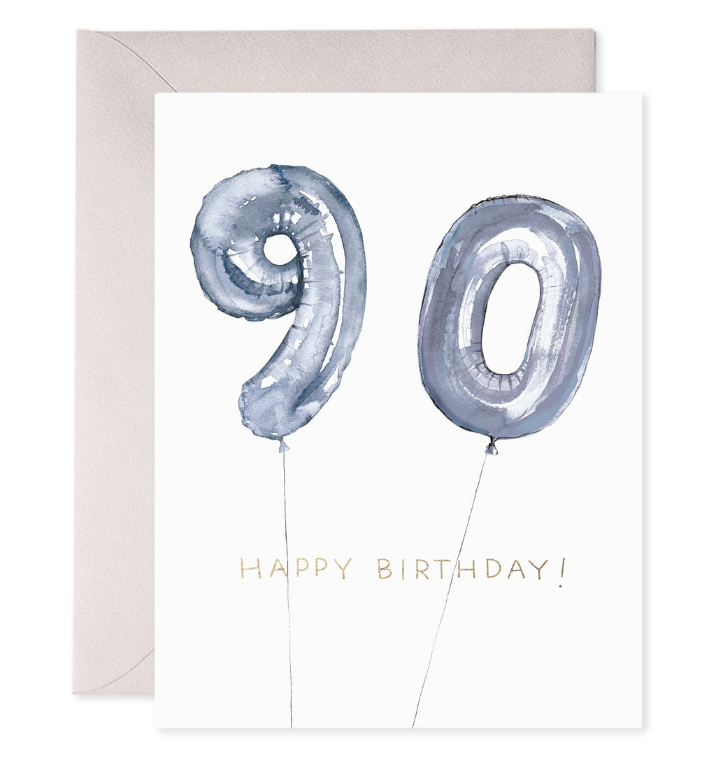 Greeting card with white background and image of a "90" as balloons with grey text says, "Happy Birthday!". Silver envelope included.