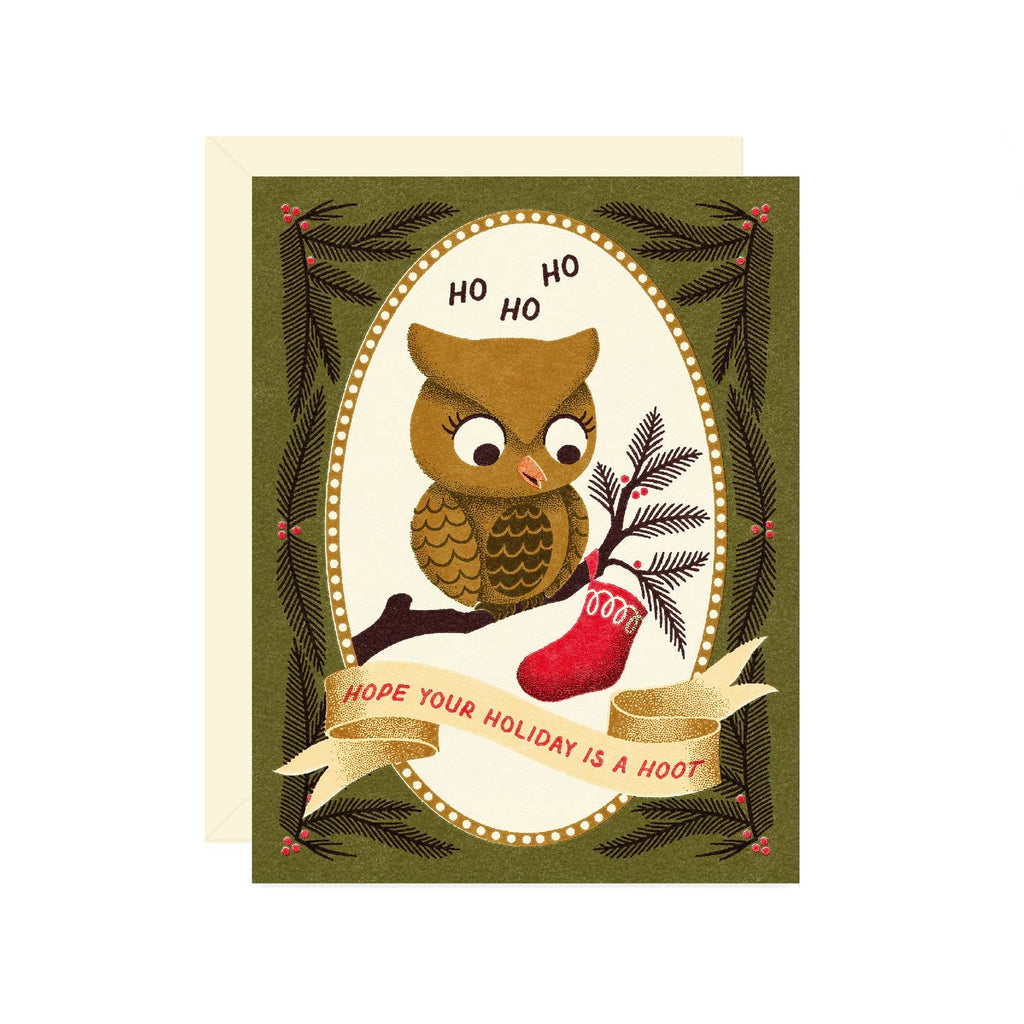 Greeting card with green background with white oval and image of a brown owl sitting on a branch with red stocking. Red text says, "Hope your holiday is a hoot". Envelope included.