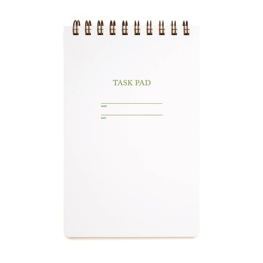 White notebook with mint green text says, "Task Pad" with two lines "Name, Date". Coiled top binding.