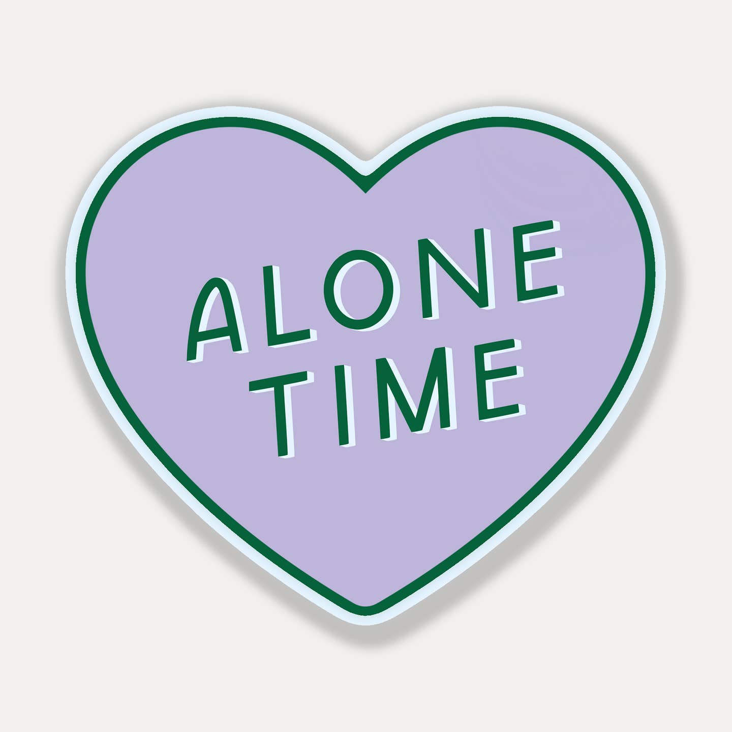 Decorative sticker in shape of heart with pink background with green text says, "alone time". 