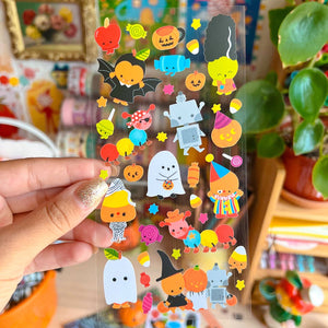 Decorative sticker sheet with clear background and images of ghosts, Frankenstein, Dracula and candy corn in costumes. 