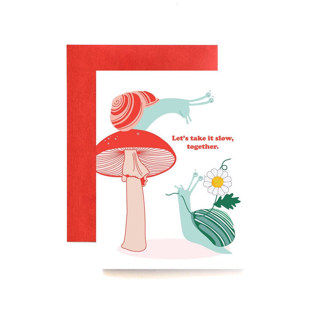White background with images of two snails, one in red and teal sitting on a mushroom and a teal snail holding a daisy.  Red text says, "Let's take it slow, together." Red envelope included.