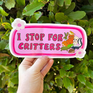 Image of bumper sticker with pink background and dark pink border with images of cat, bird, bunny, skunk and turtle. Dark pink text says "I stop for critters". 