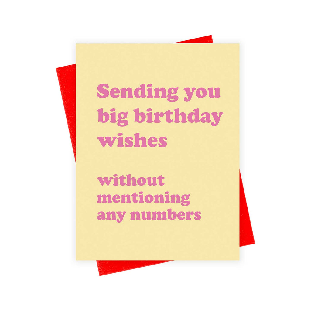 Greeting card with yellow background and pink text says, "Sending you big birthday wishes without mentioning any numbers". Red envelope included. 