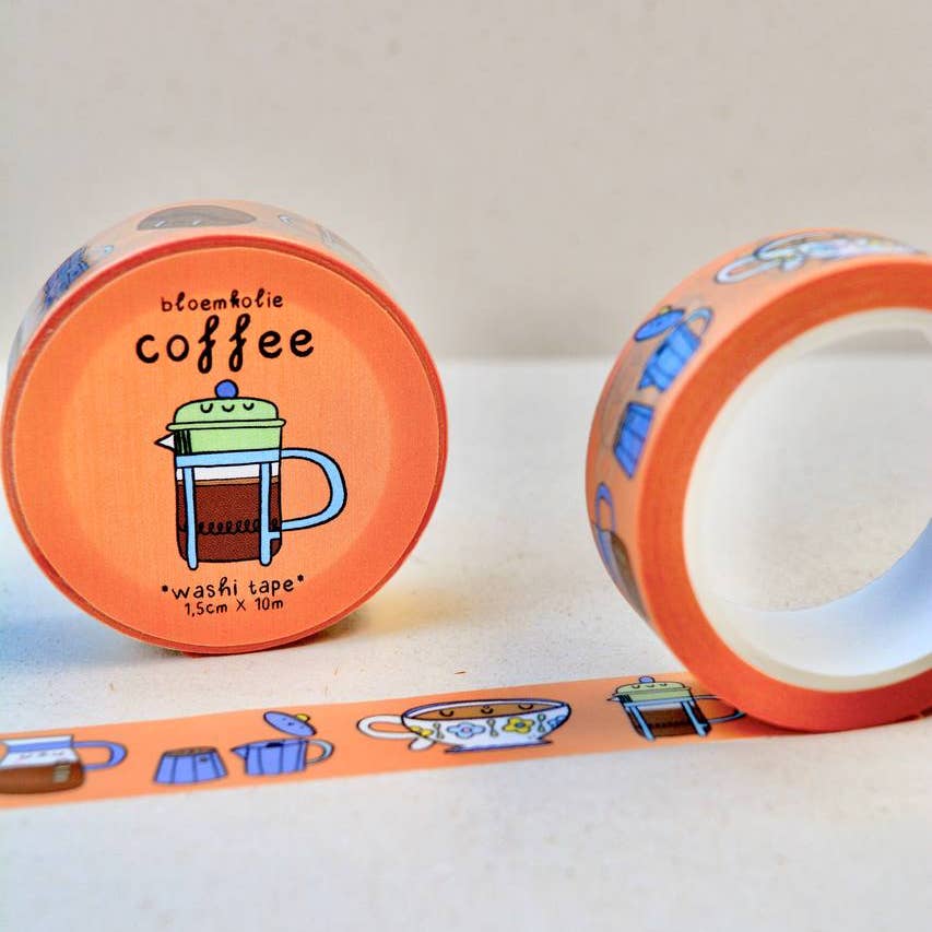 Image of roll of washi tape with peach background with images of a cup of coffee and a coffee pot and carafe of coffee in white, brown and blue. 