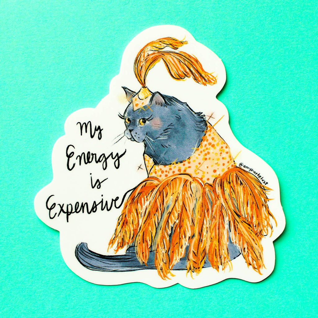 Decorative sticker with white background and image of a cat wearing an orange showgirl outfit with black text says, "My energy is expensive". 