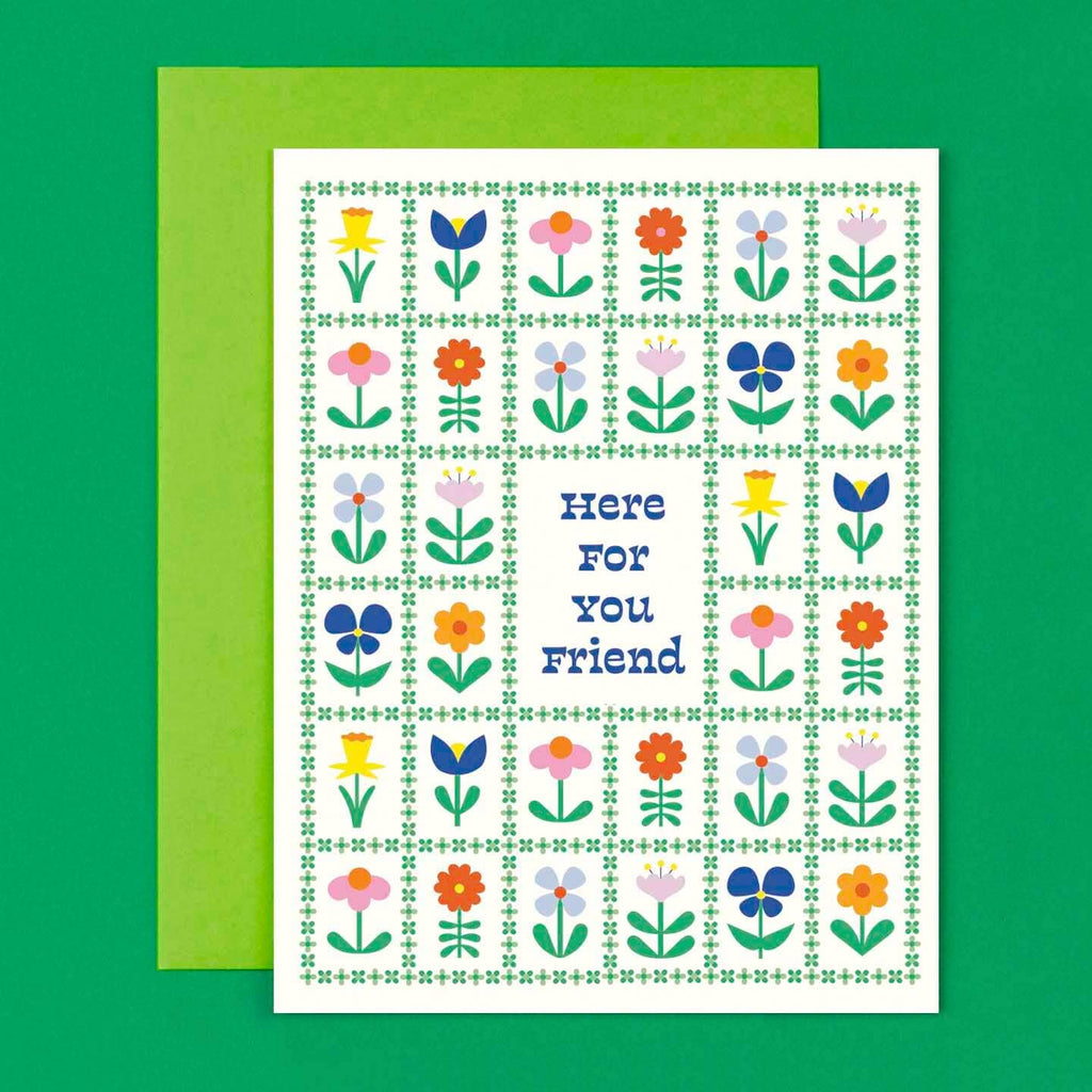 Greeting card with white background and grid of green flowers with individual flowers in each square with middle rectangle has green text says, "Here for you friend". Green envelope included. 