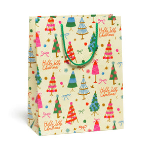 Gift bag with cream background and images of trees and bows with red text says "Holly Jolly Christmas". Green cord handle. 