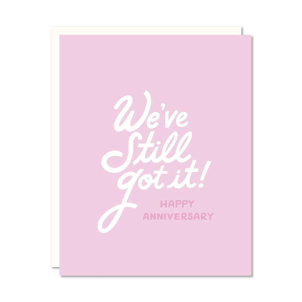 Pink background with white text says, “We’ve still got it!” and pink text says, “happy Anniversary”. White envelope included.   