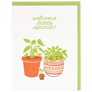 Greeting card with white background and images of two plants and a baby sprout with green text says, "Welcome little sprout!". Green envelope included. 