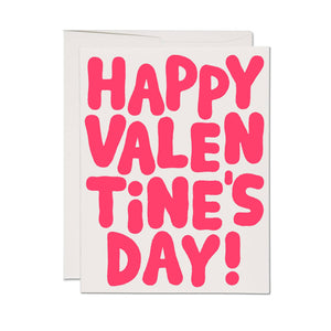 Greeting card with white background and red bubble text says, "Happy Valentine's Day!". White envelope included. 