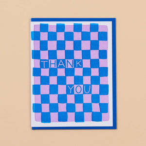 Image of card with blue and pink checkerboard pattern with blue and pink text says, "Thank you".  Blue envelope included. 