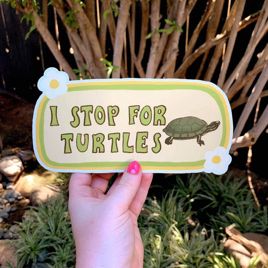 Decorative sticker with light green background with dark green border. Image of green turtle with green text says, "I stop for turtles". 