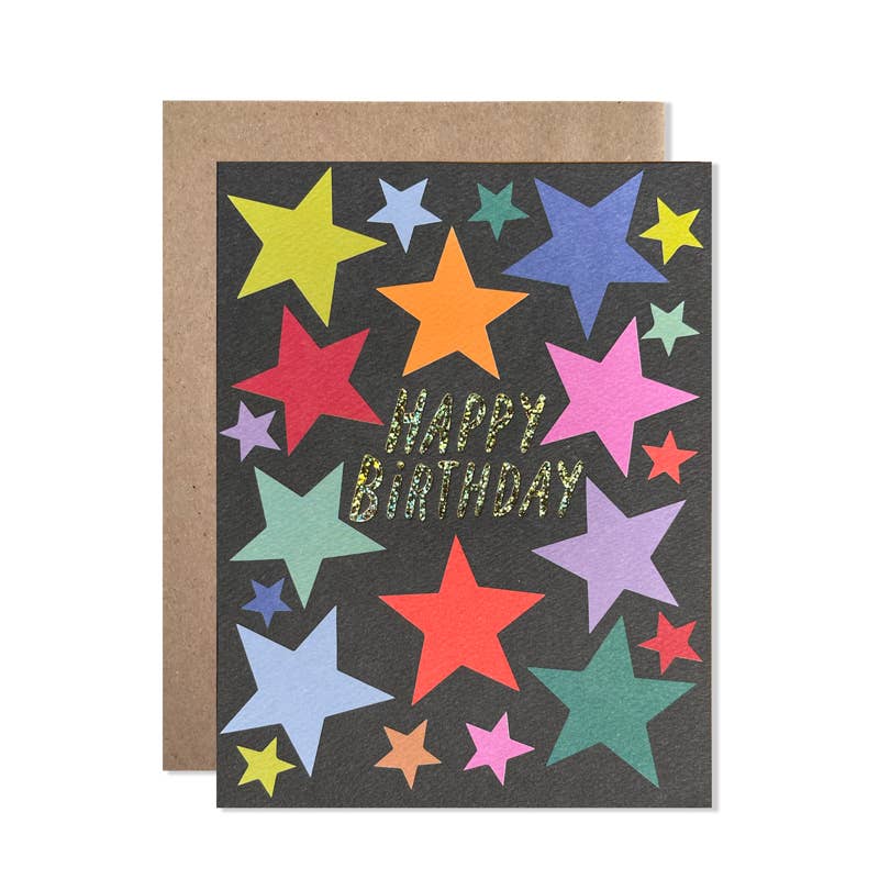 Greeting card with black background with images of stars in red, yellow, green, blue and pink with gold foil text says, "Happy Birthday". Kraft envelope included. 