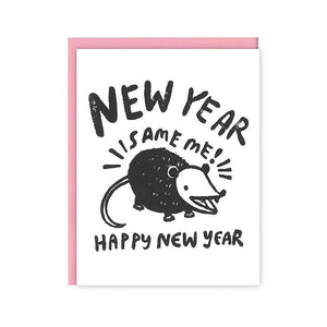 Greeting card with white background and image of possum in black and white with black text says, "New Year, Same me, Happy New Year". Pink envelope included. 