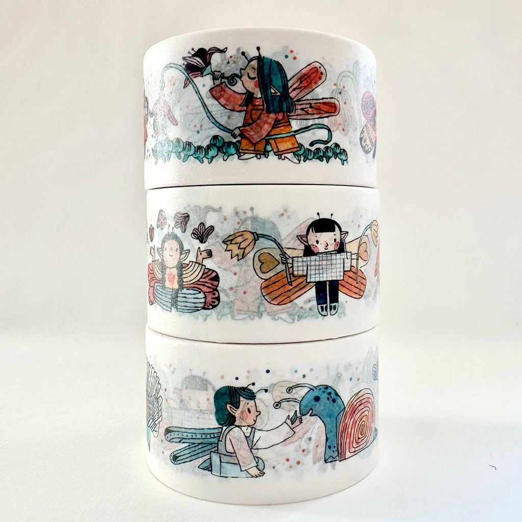 Image of washi tape with white background with images of fairies in red, blue, orange and green. 
