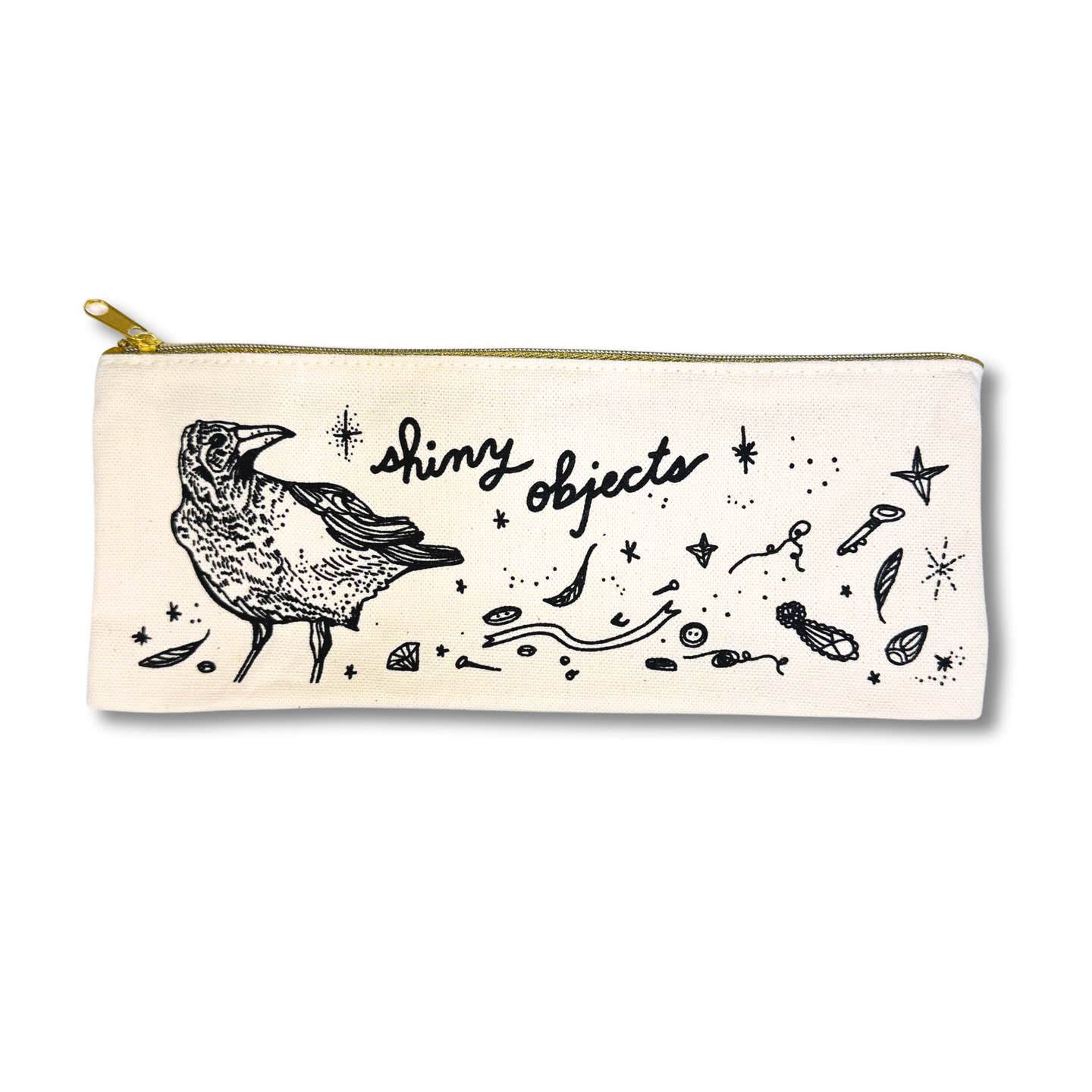 Image of a off white canvas pencil pouch with image of a black crow and many shiny items with black text says, "Shiny objects". 