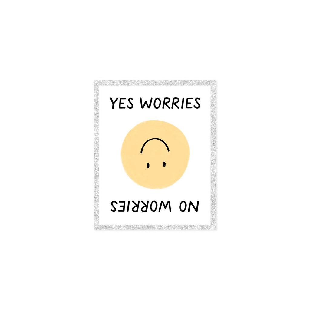 Image of decorative sticker with white background and glittery border with yellow smiley face in center and black text says, "Yes Worries" and "No worries" on top and bottom of sticker. 